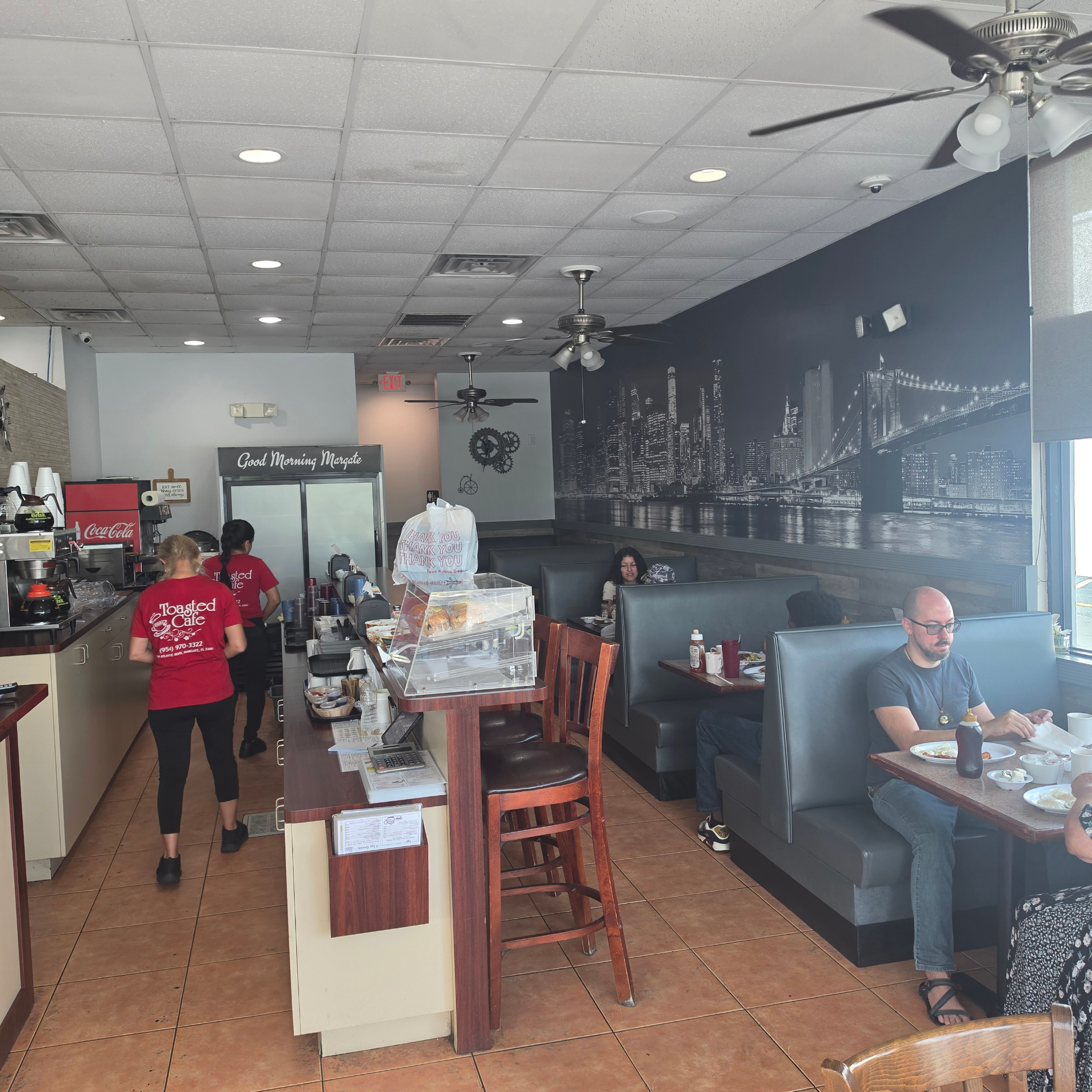 Toasted Cafe interior with Brooklyn Bridge mural
