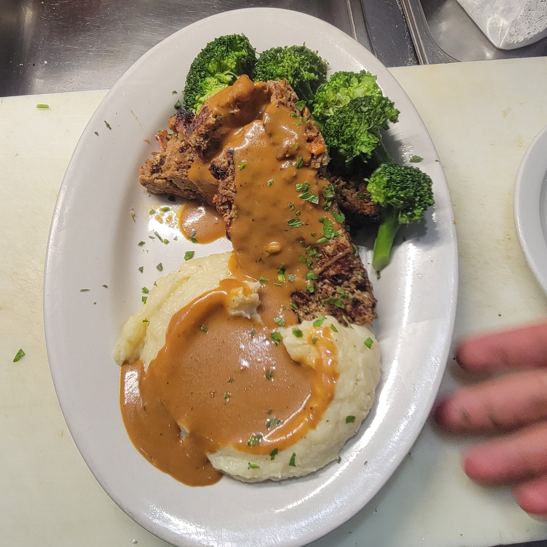 House meatloaf with mashed potatoes, gravy and steamed broccoli